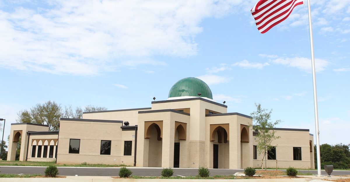 The Islamic Center of Murfreesboro's Veals Road building shortly after it was completed, with its green dome and an American flag flying in front