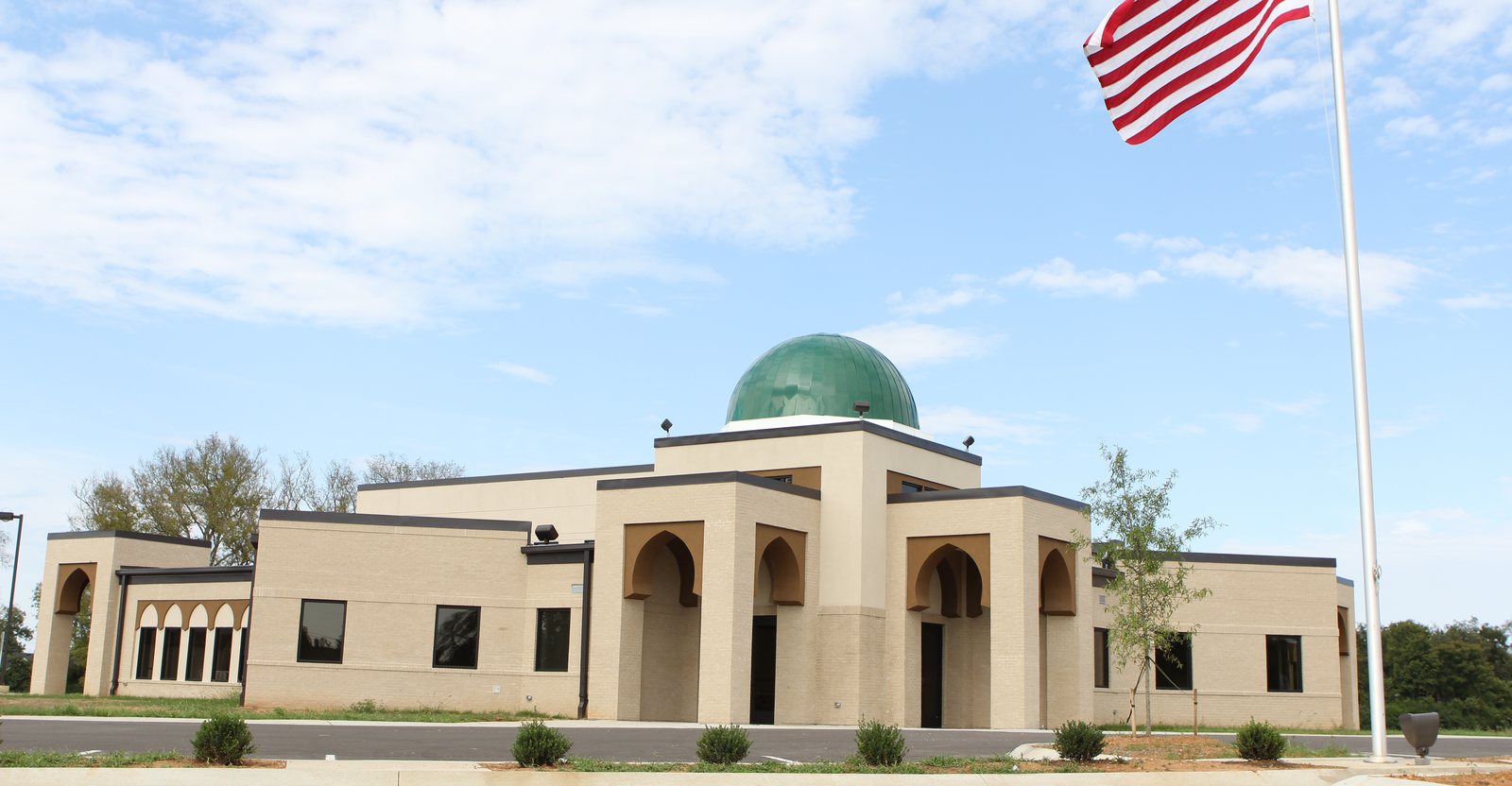 The Islamic Center of Murfreesboro's Veals Road building shortly after it was completed, with its green dome and an American flag flying in front